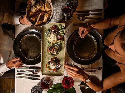 A couple enjoy a meal at the food-sharing table at the Hotel Winzer