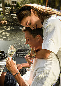 A couple enjoying a champagne breakfast on the terrace at the Adults Only Hotel Winzer