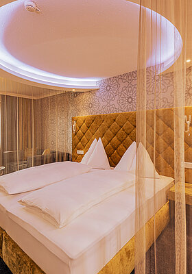 Emotion Double Room with a cosy bed at the Romantik-Wellnesshotel Winzer