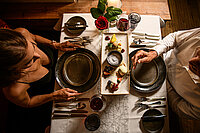 A couple enjoy a meal at the food-sharing table at the Hotel Winzer