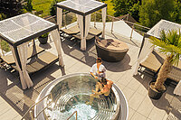 A couple enjoying the hot tub on the sun deck at the Hotel Winzer