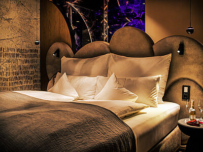 A cosy bed in a Spa Deluxe double room at the Hotel Winzer