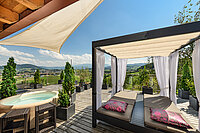 Terrace with panoramic views and a hot tub in the Kuscheltraum Superior room at Hotel Winzer