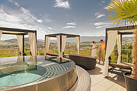 A couple are enjoying the sun on the sun deck at the Hotel Winzer